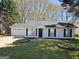 Charming single-story home with a well-manicured lawn, attached garage and black shutters at 240 Carsons Cv, Mcdonough, GA 30253