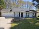 Charming single-story home with a well-manicured lawn and a two car garage in a suburban neighborhood at 240 Carsons Cv, Mcdonough, GA 30253