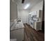 Bright kitchen featuring white cabinetry, stainless steel appliances, and hardwood floors at 240 Carsons Cv, Mcdonough, GA 30253