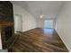 Open living room with hardwood floors, a fireplace, and lots of light at 240 Carsons Cv, Mcdonough, GA 30253