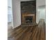 Fireplace with hardwood floors and a stone facade at 240 Carsons Cv, Mcdonough, GA 30253
