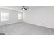 Spacious bedroom with carpet, two windows, ceiling fan, and neutral color palette at 3413 Arabian Farm Ln, Dacula, GA 30019