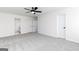 Spacious bedroom features carpet, a ceiling fan, two windows, and white doors at 3413 Arabian Farm Ln, Dacula, GA 30019