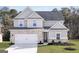 Charming two-story home with a brick and siding facade, attached garage, and well-manicured lawn at 3413 Arabian Farm Ln, Dacula, GA 30019