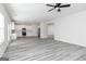 Open-concept kitchen with white cabinets, stainless steel appliances, and grey wood-look floors at 3413 Arabian Farm Ln, Dacula, GA 30019