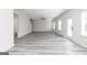 Spacious living area featuring grey wood-look floors, a ceiling fan, and an open concept design at 3413 Arabian Farm Ln, Dacula, GA 30019