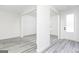 Bright, open-concept living space with grey wood-look floors, white trim, and plenty of natural light at 3413 Arabian Farm Ln, Dacula, GA 30019