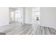 Open-concept living space featuring grey wood-look floors, white trim, and an open view to the kitchen at 3413 Arabian Farm Ln, Dacula, GA 30019
