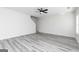 Spacious living area featuring grey wood-look floors, a ceiling fan, and an open concept design at 3413 Arabian Farm Ln, Dacula, GA 30019