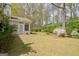 Well-maintained backyard with lush green grass, mature trees, and flowering bushes at 1010 Pinehurst Dr, Peachtree City, GA 30269