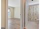 View of an empty bedroom and a partially opened bathroom with a shower curtain at 1010 Pinehurst Dr, Peachtree City, GA 30269