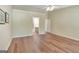 Bedroom with hardwood floors and neutral walls with an en suite bathroom and ample space at 1010 Pinehurst Dr, Peachtree City, GA 30269