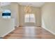 Bright dining room with hardwood floors, chandelier, and large window providing ample natural light at 1010 Pinehurst Dr, Peachtree City, GA 30269