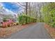 Long paved driveway lined with mature trees and lush greenery at 1010 Pinehurst Dr, Peachtree City, GA 30269