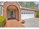 Detailed view of the home's brick-paved entrance and two-car garage at 1010 Pinehurst Dr, Peachtree City, GA 30269