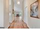 Long hallway with hardwood floors leading to a living area with a fireplace at 1010 Pinehurst Dr, Peachtree City, GA 30269