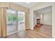 Inviting living room with hardwood floors, fireplace, and glass doors leading to a sunroom at 1010 Pinehurst Dr, Peachtree City, GA 30269