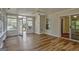 Bright sun room featuring hardwood floors, multiple windows, and access to the outdoors at 1010 Pinehurst Dr, Peachtree City, GA 30269