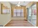 Cozy sun room with hardwood floors, a ceiling fan, and sliding glass door leading to the outdoors at 1010 Pinehurst Dr, Peachtree City, GA 30269