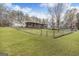Spacious backyard view from the home with a covered porch and a fenced in pool at 12435 Hamilton Rd # 536/- Ac, Chattahoochee Hills, GA 30268