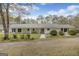 Ranch-style home with a covered front porch, manicured landscaping, and a gravel driveway at 12435 Hamilton Rd # 536/- Ac, Chattahoochee Hills, GA 30268