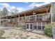 Back exterior of home with covered porch, deck, stone landscaping, and natural lighting at 12435 Hamilton Rd # 536/- Ac, Chattahoochee Hills, GA 30268