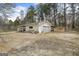 Exterior of garage with gravel, side door, and car port at 12435 Hamilton Rd # 536/- Ac, Chattahoochee Hills, GA 30268