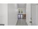 View down the tiled hallway, showcasing natural light and wood floors at 12435 Hamilton Rd # 536/- Ac, Chattahoochee Hills, GA 30268
