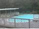 Inviting backyard pool with decorative fencing and seating area, perfect for summer relaxation and entertaining at 12435 Hamilton Rd # 536/- Ac, Chattahoochee Hills, GA 30268