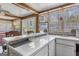Bright sunroom with large windows, tile countertops, sink, and exposed wooden beams at 12435 Hamilton Rd # 536/- Ac, Chattahoochee Hills, GA 30268