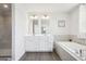 The bathroom features a double sink vanity, sleek fixtures, and a luxurious soaking tub for ultimate relaxation at 864 Maduro Way, Mcdonough, GA 30253