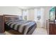 This bedroom has cozy gray and black bedding, two large windows, and a convenient television setup at 864 Maduro Way, Mcdonough, GA 30253