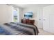 This bedroom has gray and black bedding, one bright window, and a convenient television setup at 864 Maduro Way, Mcdonough, GA 30253