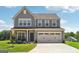 Charming two-story home featuring a gray exterior, a two car garage, and a beautifully landscaped front yard at 864 Maduro Way, Mcdonough, GA 30253