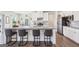 Modern kitchen featuring white cabinets, stainless steel appliances, breakfast bar, granite countertop and seating at 864 Maduro Way, Mcdonough, GA 30253
