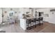 Spacious kitchen and breakfast nook with stainless steel appliances and granite countertop island at 864 Maduro Way, Mcdonough, GA 30253