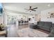 Open concept living room and kitchen area featuring a breakfast bar, modern ceiling fan and hardwood floors at 864 Maduro Way, Mcdonough, GA 30253