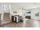 Cozy living room with large sectional, mounted TV, hardwood floors, modern ceiling fan and lots of natural light at 864 Maduro Way, Mcdonough, GA 30253