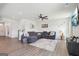 Cozy living room with large sectional, mounted TV, hardwood floors, modern ceiling fan and plenty of natural light at 864 Maduro Way, Mcdonough, GA 30253
