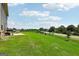 Spacious backyard featuring lush green grass with a partial view of the road at 864 Maduro Way, Mcdonough, GA 30253