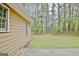 A well-maintained backyard features a lawn and mature trees at 212 Bella Rosa, Peachtree City, GA 30269
