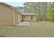 Backyard features a patio, lush lawn, mature trees, and a cozy chair at 212 Bella Rosa, Peachtree City, GA 30269
