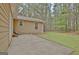 Spacious backyard featuring a lawn, a chair on the patio, and lush trees at 212 Bella Rosa, Peachtree City, GA 30269