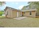 Backyard view includes a lawn, patio, chair, trees and the home's exterior at 212 Bella Rosa, Peachtree City, GA 30269