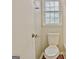 Bathroom with toilet next to a window with blinds and a door at 212 Bella Rosa, Peachtree City, GA 30269