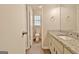 Bright bathroom features granite counters, modern fixtures, and wood-look floors at 212 Bella Rosa, Peachtree City, GA 30269