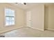 Bedroom with a window, neutral carpet, and a white closet door at 212 Bella Rosa, Peachtree City, GA 30269