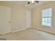 Carpeted bedroom with a window and two doors at 212 Bella Rosa, Peachtree City, GA 30269