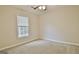 Bedroom with window, carpeted floors and ceiling fan at 212 Bella Rosa, Peachtree City, GA 30269