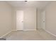 Bedroom with neutral carpeting and two white doors at 212 Bella Rosa, Peachtree City, GA 30269